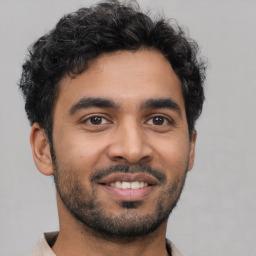 Joyful latino young-adult male with short  black hair and brown eyes