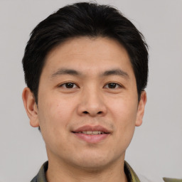 Joyful asian young-adult male with short  brown hair and brown eyes