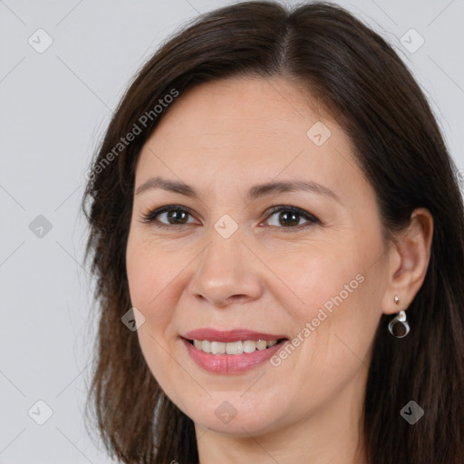 Joyful white adult female with long  brown hair and brown eyes