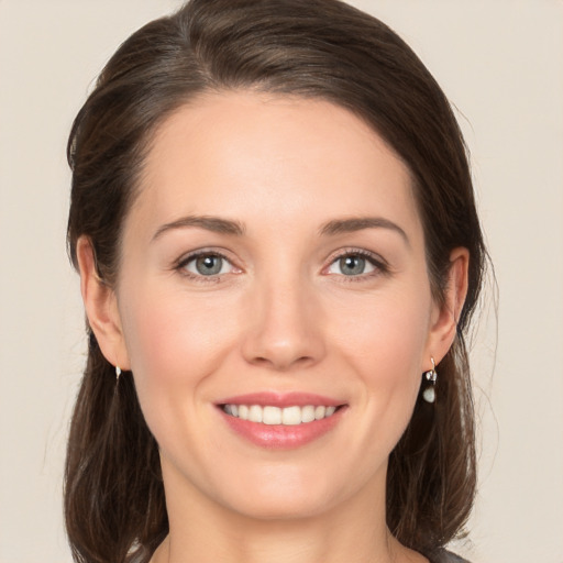 Joyful white young-adult female with medium  brown hair and brown eyes