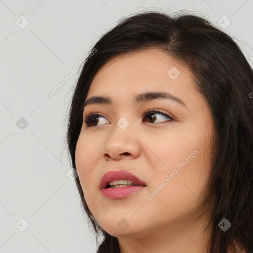 Joyful asian young-adult female with long  brown hair and brown eyes