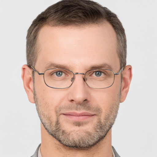 Joyful white adult male with short  brown hair and brown eyes