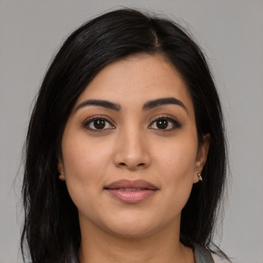 Joyful latino young-adult female with long  black hair and brown eyes
