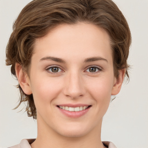 Joyful white young-adult female with medium  brown hair and green eyes