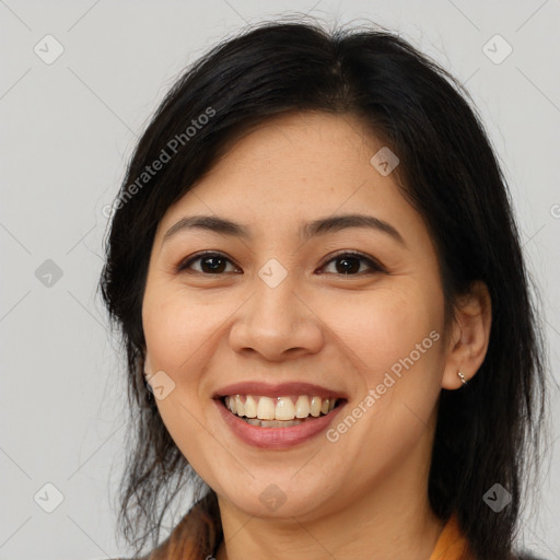 Joyful latino young-adult female with medium  brown hair and brown eyes