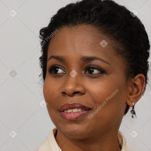 Joyful black young-adult female with short  brown hair and brown eyes