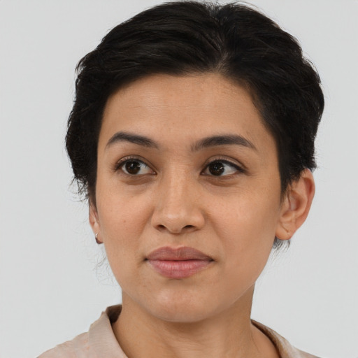Joyful latino young-adult female with short  brown hair and brown eyes