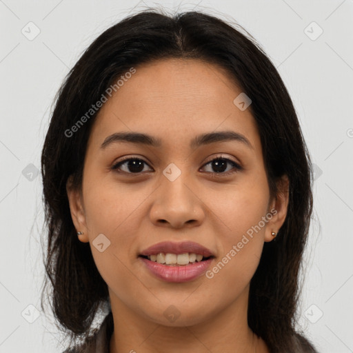 Joyful latino young-adult female with long  brown hair and brown eyes