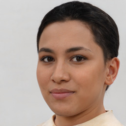 Joyful latino young-adult female with short  brown hair and brown eyes