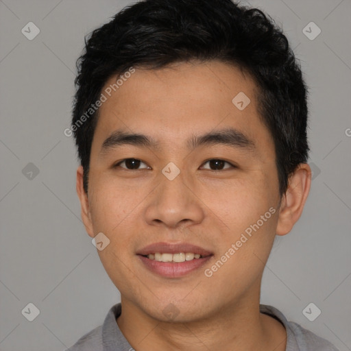 Joyful asian young-adult male with short  brown hair and brown eyes