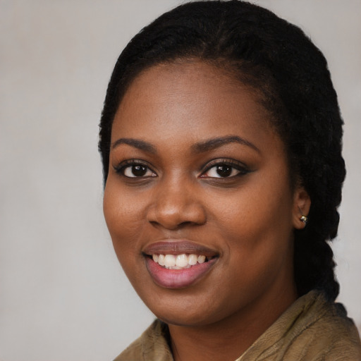 Joyful black young-adult female with long  black hair and brown eyes