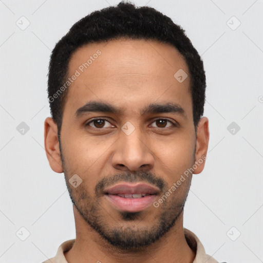 Joyful latino young-adult male with short  black hair and brown eyes