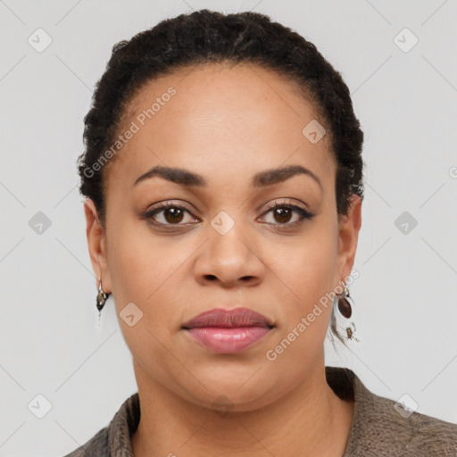 Joyful black young-adult female with short  black hair and brown eyes