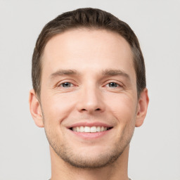 Joyful white young-adult male with short  brown hair and brown eyes