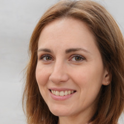 Joyful white adult female with long  brown hair and brown eyes