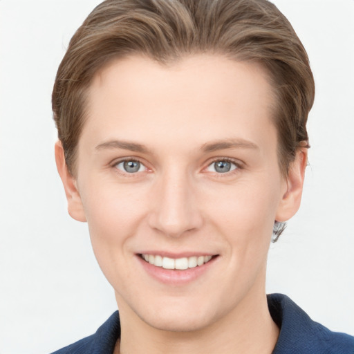 Joyful white young-adult female with short  brown hair and grey eyes