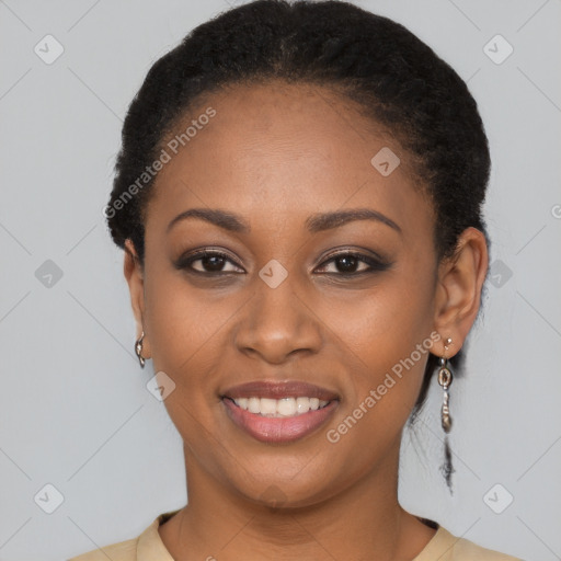 Joyful black young-adult female with long  black hair and brown eyes