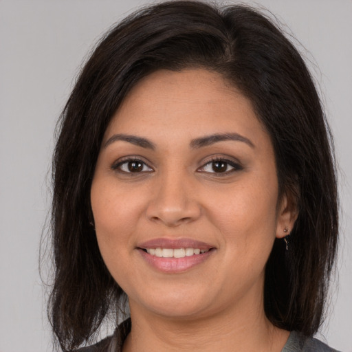 Joyful white young-adult female with medium  brown hair and brown eyes