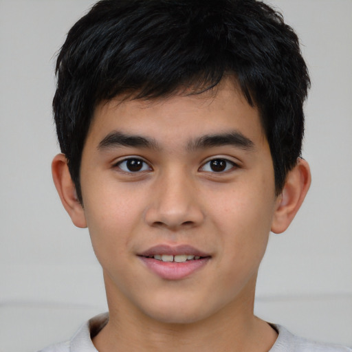 Joyful asian child male with short  brown hair and brown eyes