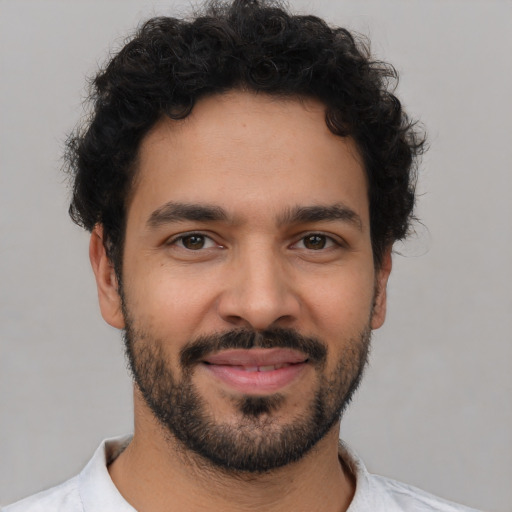 Joyful latino young-adult male with short  brown hair and brown eyes