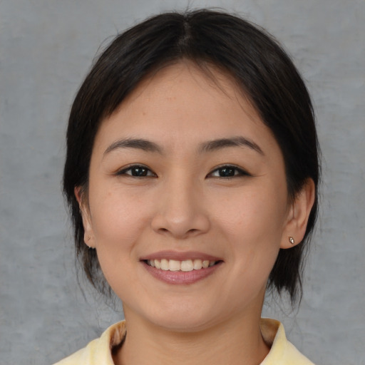 Joyful white young-adult female with medium  brown hair and brown eyes