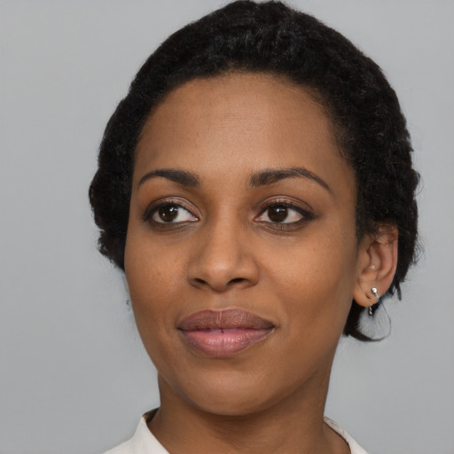 Joyful black young-adult female with medium  black hair and brown eyes