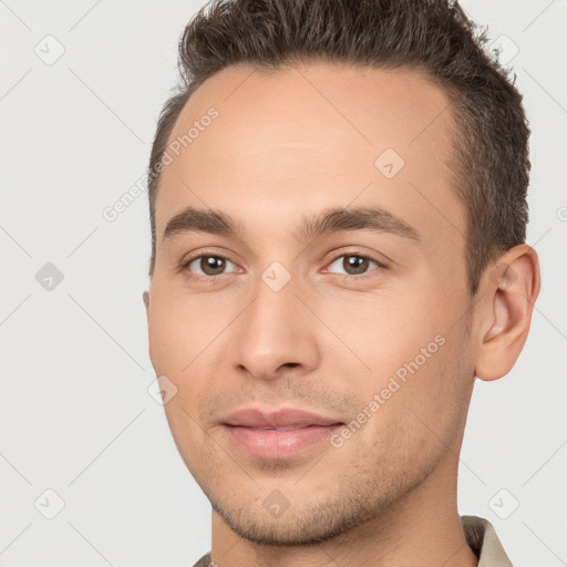 Joyful white young-adult male with short  brown hair and brown eyes