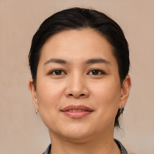 Joyful asian young-adult female with medium  brown hair and brown eyes
