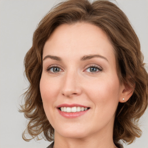 Joyful white young-adult female with medium  brown hair and green eyes