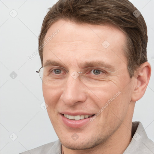 Joyful white adult male with short  brown hair and grey eyes