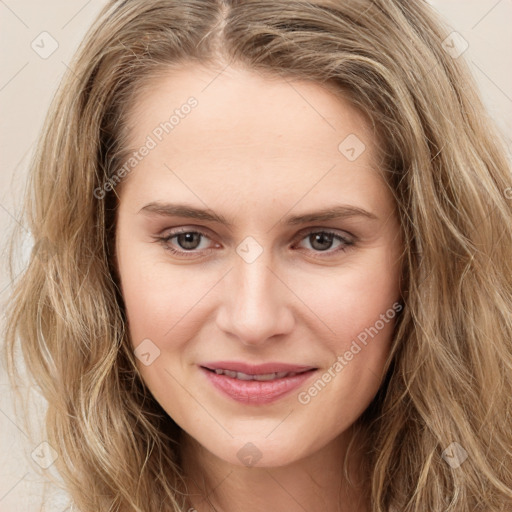 Joyful white young-adult female with long  brown hair and green eyes