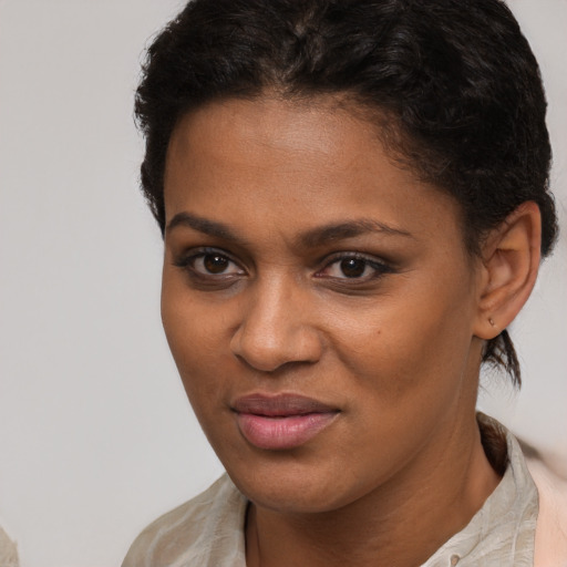 Joyful black young-adult female with short  brown hair and brown eyes