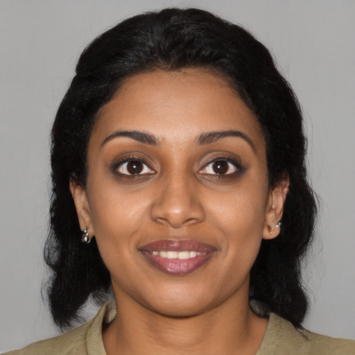 Joyful black young-adult female with medium  black hair and brown eyes