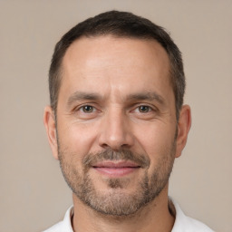 Joyful white adult male with short  brown hair and brown eyes