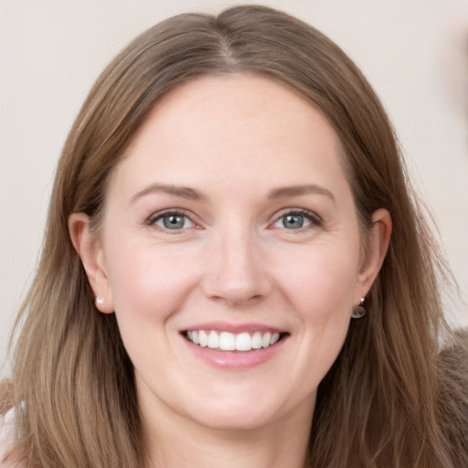 Joyful white young-adult female with long  brown hair and grey eyes