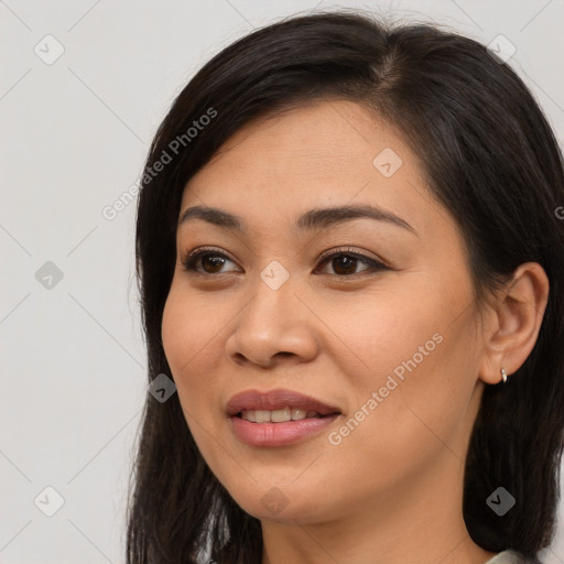 Joyful asian young-adult female with long  brown hair and brown eyes