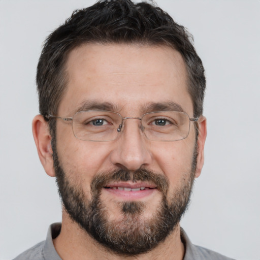 Joyful white adult male with short  brown hair and brown eyes