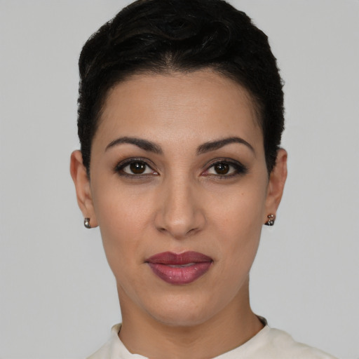 Joyful latino young-adult female with short  brown hair and brown eyes