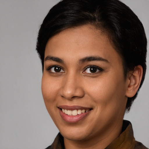 Joyful latino young-adult female with medium  brown hair and brown eyes