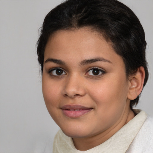 Joyful latino young-adult female with short  brown hair and brown eyes