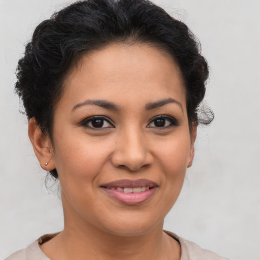 Joyful latino young-adult female with short  brown hair and brown eyes