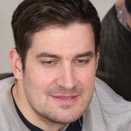 Joyful white adult male with short  brown hair and brown eyes