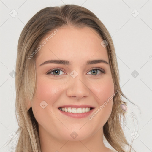 Joyful white young-adult female with long  brown hair and blue eyes