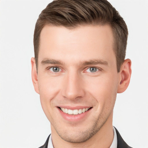 Joyful white young-adult male with short  brown hair and grey eyes