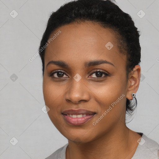 Joyful black young-adult female with short  black hair and brown eyes