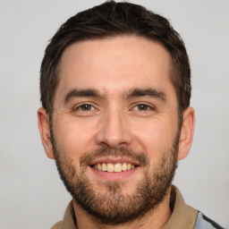 Joyful white young-adult male with short  brown hair and brown eyes