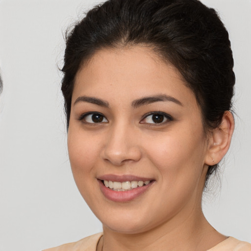 Joyful latino young-adult female with medium  brown hair and brown eyes