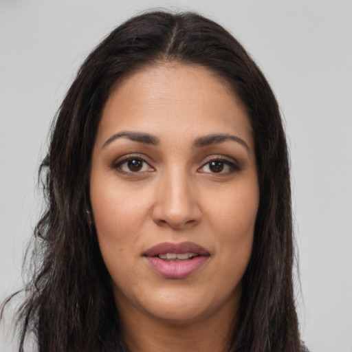 Joyful latino young-adult female with long  brown hair and brown eyes