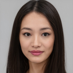 Joyful asian young-adult female with long  brown hair and brown eyes