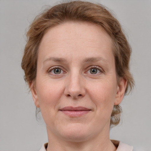 Joyful white adult female with medium  brown hair and blue eyes